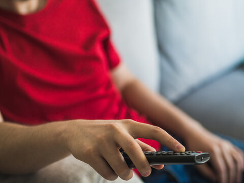 Sedentary Man Changing Television Channel With The Remote Control. Sedentary Life Concept