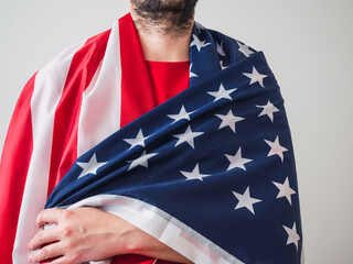 Unrecognizable man hugging the US flag