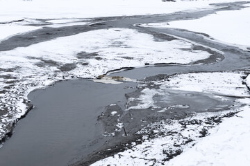 Frozen river, thawed places, beautiful landscape