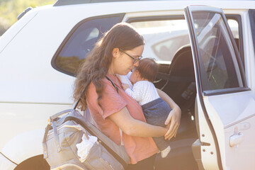 mother with young baby ready to go out for a trip in car