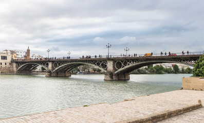 Fototapeta premium Famous Triana bridge over the Guadalquivir river in Seville (Spain)