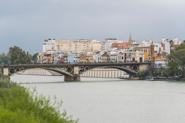 Famous Triana bridge over the Guadalquivir river in Seville (Spain)
