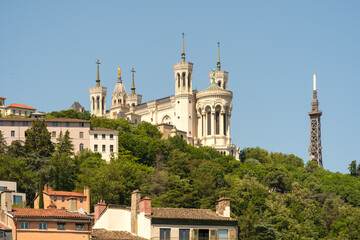 Fototapeta na wymiar View of the basilica Fourviere at the top of hill and residential buildings at the picturesque city
