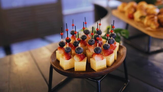Canapes with cheese, strawberries and grapes. Shooting delicious food close-up