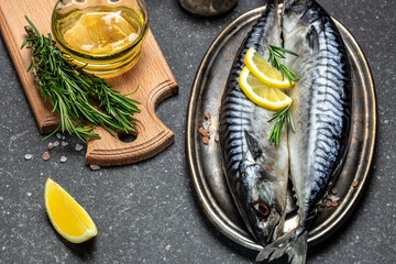 marinated mackerel or herring fish with salt, lemon and spices on a metal tray. Seafood concept....