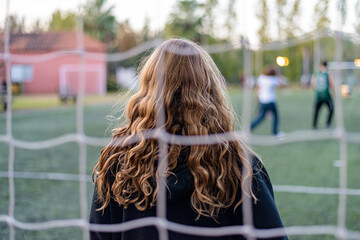 Football net and a girl with long hair