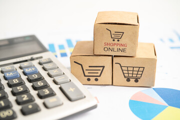 Shopping online box with credit card and calculator on graph. Finance commerce import export business concept.