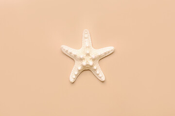 Fototapeta na wymiar Starfish sea on beach beige background. Summer background. Decorative textile . Isolated object.