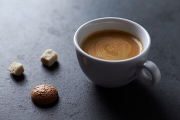 Cup of coffee on dark stone background. Close up. Copy space.
