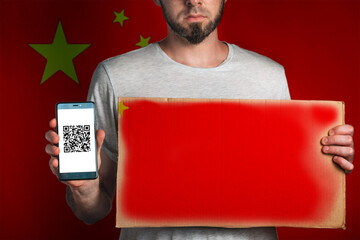 Concept of freedoms and human rights. A man with a cardboard and a phone in his hand. The Flag of...
