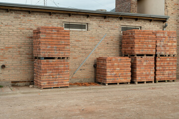 Pallets of orange bricks for construction