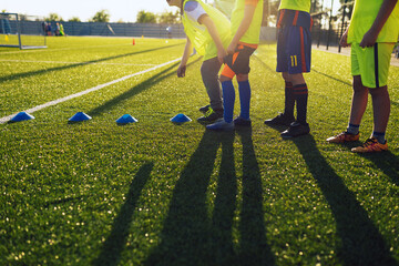 School kids standing in a row at physical education training session. Happy children play sports on sunny summer day - obrazy, fototapety, plakaty