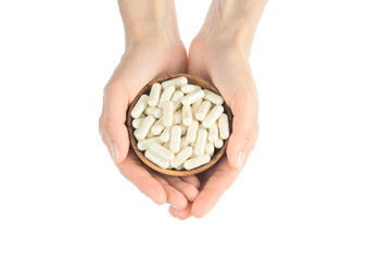White capsules. Female hands holds white capsule collagen