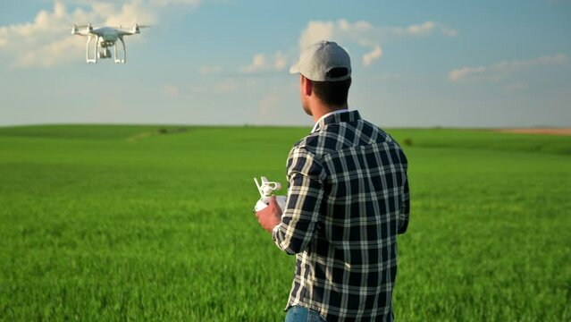 Smart farming concept, latin american farmer using drone in field on a sunny day. Concept of new technologies in agriculture. High quality 4k footage