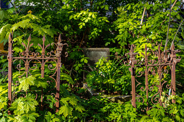 old rusty fence on the grave in the cemetery