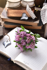 Small bunch of clover flowers on rustic style table