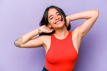 Fototapeta na wymiar Young hispanic woman isolated on purple background stretching arms, relaxed position.