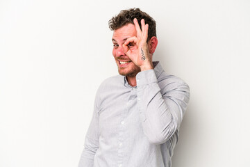 Young caucasian man isolated on white background excited keeping ok gesture on eye.