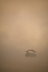 motor boat floating on the water in thick fog