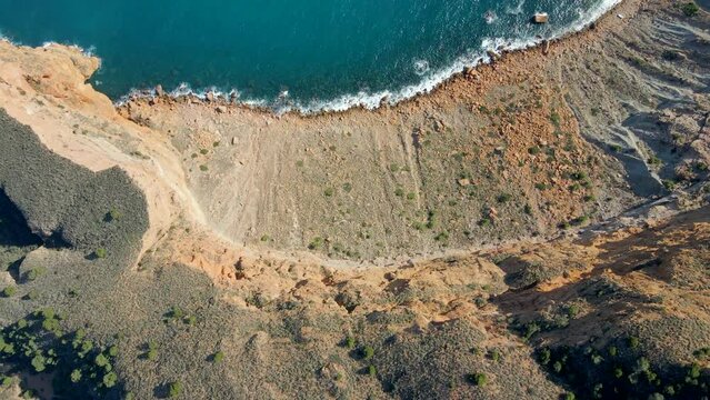 Aerial view of cliff on the beautiful coast of the Serra Gelada natural park. Alicante, Spain. Top down view.