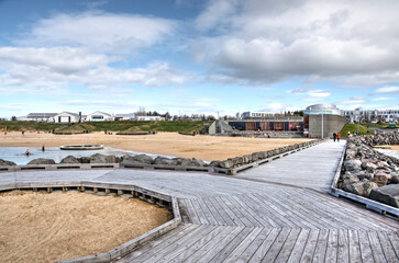 Reykjavik, Iceland, April 21, 2022: wooden walkways at the beach in seaside resort Nautholsvik on a...