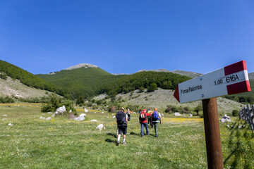 Hikers walk towards Forca Palomba in the Ernici Mountains. Monti Ernici, Pizzo Deta, Frosinone, Lazio, Italy, Europe