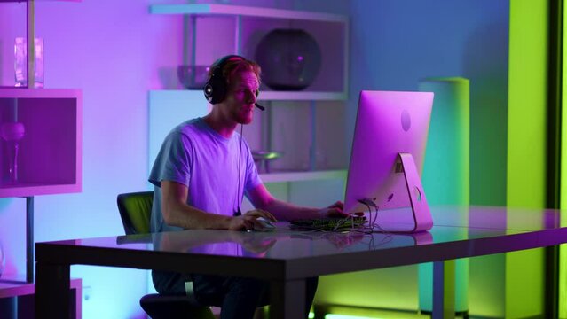 Cyber gamer talking microphone at home. Esport streamer comment actions in neon