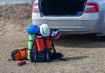 Tourist's backpack on the ground against the background of a car close-up
