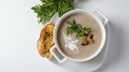 Mushroom Cream Soup with fried champignons and fresh parsley. Winter, autumn hot soup concept