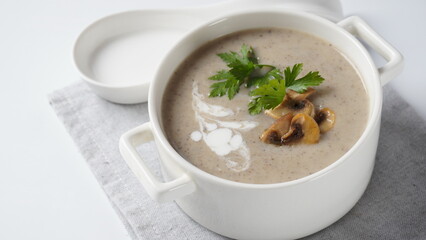 Mushroom Cream Soup with fried champignons and fresh parsley. Winter, autumn hot soup concept