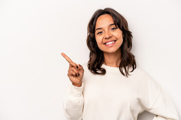 Young hispanic woman isolated on white background smiling cheerfully pointing with forefinger away.