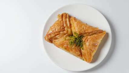 Baklava a layered pastry dessert made of filo pastry, filled with chopped nuts, and sweetened with syrup or honey.