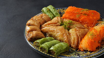 A tray of Turkish pastries including baklava, knafeh -  a Middle Eastern cheese pastry soaked in sweet, sugar-based syrup