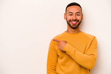 Young hispanic man isolated on white background smiling and pointing aside, showing something at blank space.