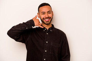 Young hispanic man isolated on white background showing a mobile phone call gesture with fingers.