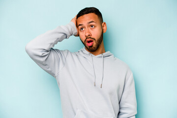 Young hispanic man isolated on blue background being shocked, she has remembered important meeting.