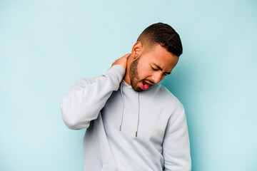 Young hispanic man isolated on blue background suffering neck pain due to sedentary lifestyle.