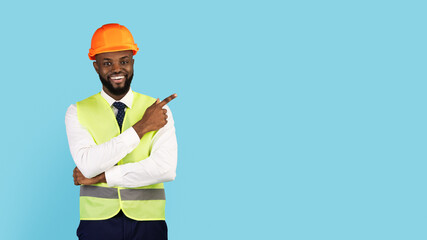 Check This. Black Male Construction Engineer Pointing Finger Aside At Copy Space