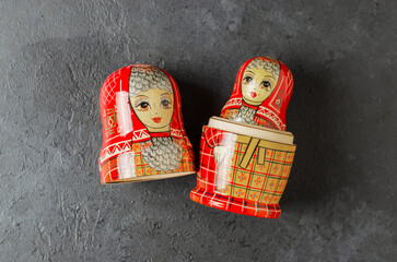 A red matryoshka doll on a black background. Traditional Russian toy.