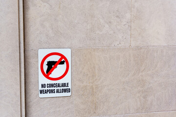 Sign on building stating No Concealable Weapons Allowed