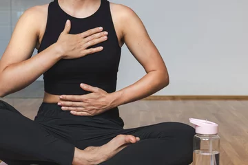 Abwaschbare Fototapete Woman doing breathing exercise sitting in lotus position. © Barillo_Picture
