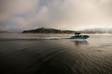 beautiful view on water surface and motor boat quickly floating on it