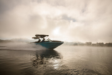 bright blue motorboat quickly floating on the water