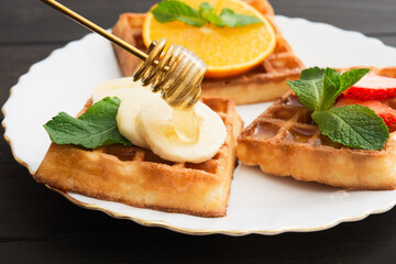 Closeup view of belgium waffles with different fruits and berries