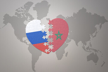 puzzle heart with the national flag of russia and morocco on a world map background. Concept.