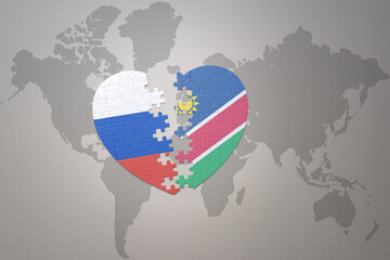 puzzle heart with the national flag of russia and namibia on a world map background. Concept.