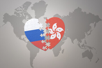 puzzle heart with the national flag of russia and hong kong on a world map background. Concept.