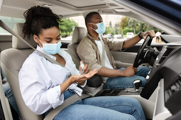 African American Family Riding Car And Disinfecting Hands With Sanitizer