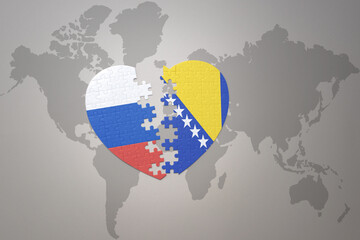puzzle heart with the national flag of russia and bosnia and herzegovina on a world map background. Concept.