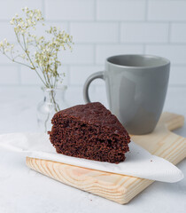 Chocolate cake and a cup of Coffee on a wooden tray. Closeup picture